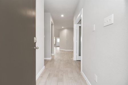 Greeted by a elegant glass front door (to be installed), the entrance beckons with high ceilings, adorned with elegant wood-look tile flooring and oversized baseboards. Sample photo of completed home with similar floor plan. Actual colors and selections may vary.