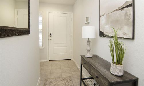 Doorway to outside featuring light tile patterned floors