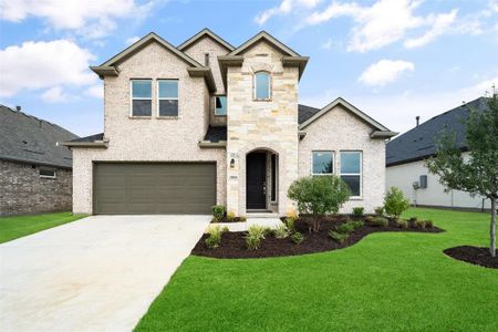 View of front of house with a garage and a front yard