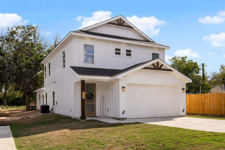 View of front facade featuring central air condition unit, a garage, and a front lawn