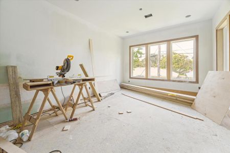 The dining room is tucked just beyond the kitchen and offers views of the lush yard space. All windows in the home are trimmed and cased, all main living areas feature recessed lighting, 8 inch baseboards, wood flooring and level 4 smooth finish walls. Photo as of 7/30/24