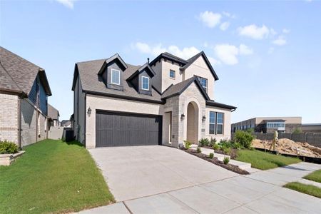 View of front of property with a garage, central AC, and a front lawn