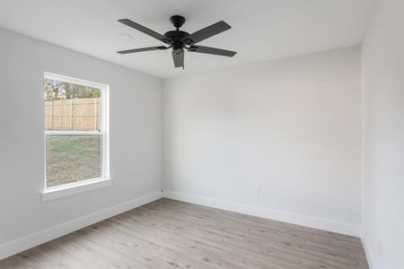 Empty room featuring ceiling fan and light hardwood / wood-style floors