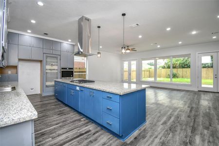 Open concept featuring 10ft ceilings and vinyl flooring with rustic wood grain.