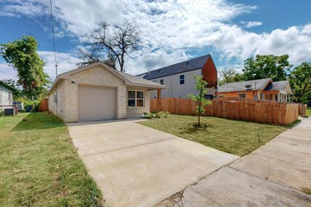 View of front facade with a garage and a front lawn