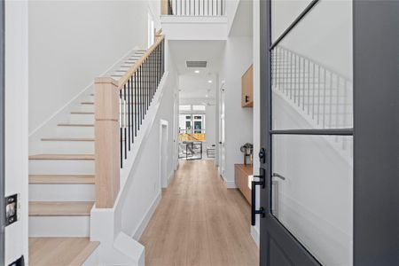 The 22-foot entry makes a bold statement, opening into a warm, inviting living area featuring Vecino’s hallmark Roman Clay accent wall and a striking fireplace.