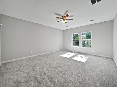 Spare room featuring carpet flooring and ceiling fan