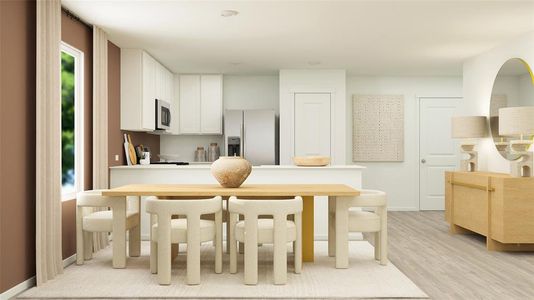 Kitchen featuring fridge with ice dispenser, light hardwood / wood-style floors, and white cabinetry