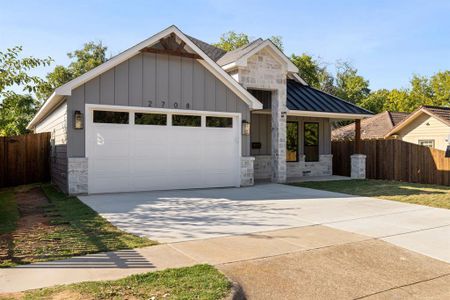 View of front of home featuring a garage and a front yard