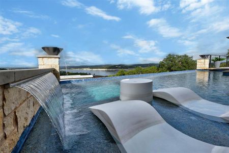 Absolutely stunning pool complete with waterfall and fire bowls overlooking the lake.