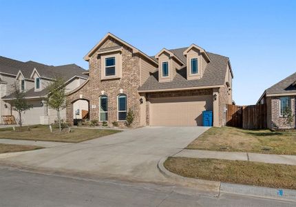 View of front of house with a garage and a front lawn