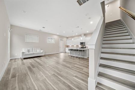 Upon entry to the IMMACULATE BRAND NEW HOME high ceilings greet you, upstairs living space access and Foyer leading to Luxurious Living Room & more.