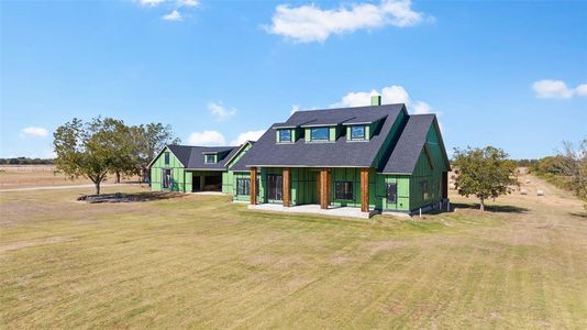 Back of house with a lawn and a porch