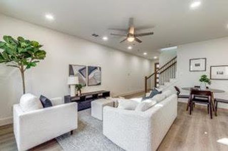 Living room with hardwood / wood-style flooring and ceiling fan