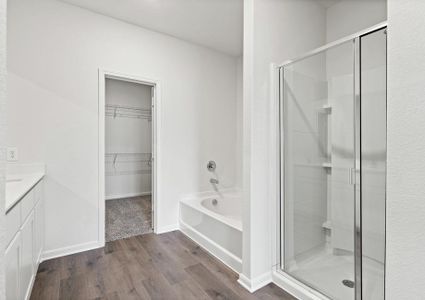 The master bathroom of the Cypress has a walk-in, glass shower and a large garden tub.