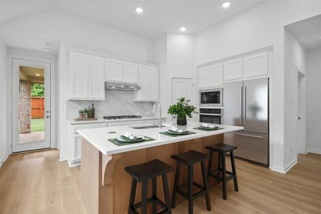 Kitchen with large island for additional seating.