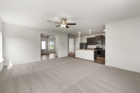 Living room featuring ceiling fan and light colored carpet