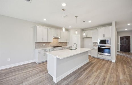 Kitchen with oversized island*real home pictured