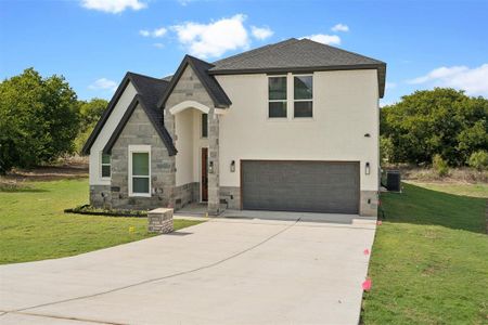 View of front of house with a front yard and a garage