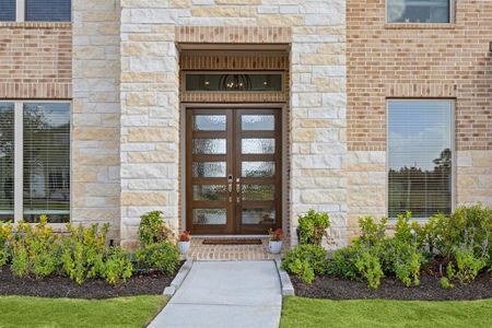 Entry to this home is through Mahogany and glass French entry doors accented with a transom window.