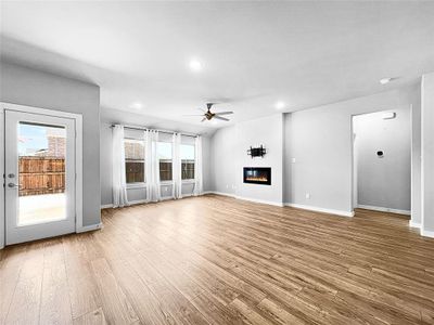 Unfurnished living room featuring light hardwood / wood-style flooring and ceiling fan