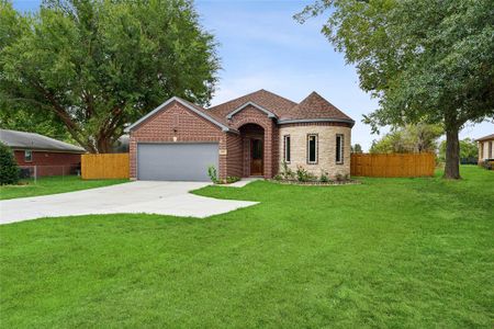 View of front of house with a garage and a front yard