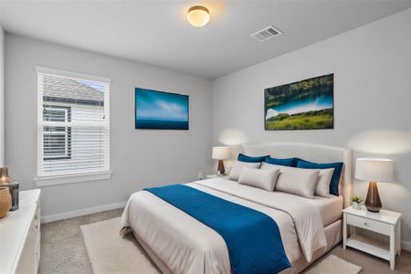 Secondary bedroom features plush carpet, custom paint and a large window with privacy blinds.