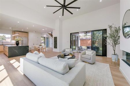 Living room featuring ceiling fan, light hardwood / wood-style floors, and a wealth of natural light