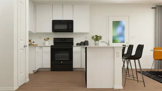 Kitchen with white cabinetry, hardwood / wood-style floors, and electric range oven
