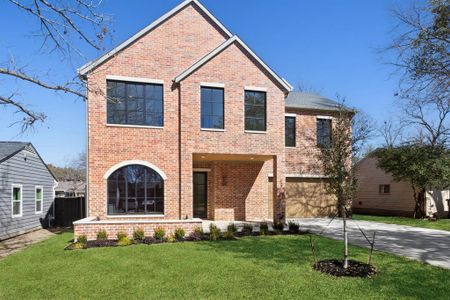 Front of property featuring a front seating and  cedar garage doors