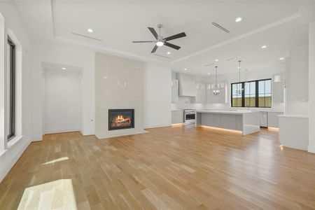 Relax and entertain in the large family room open to the kitchen. The gas log fireplace is a focal point and is wired and set for a television above it. large windows overlook the courtyard with Lanai and summer kitchen.