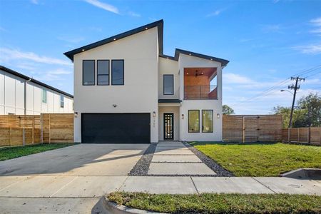 Contemporary house with a balcony, a front lawn, and a garage