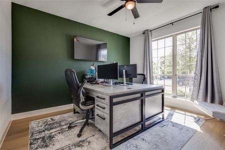Office area with ceiling fan and hardwood / wood-style flooring