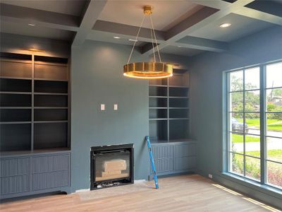 Study/Office with gas fireplace, custom reeded cabinetry and Visual Comfort Lighting.