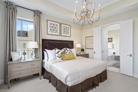 Comfortable and inviting master suite flooded with natural light. Photo is of an existing home & used for representative purposes only.