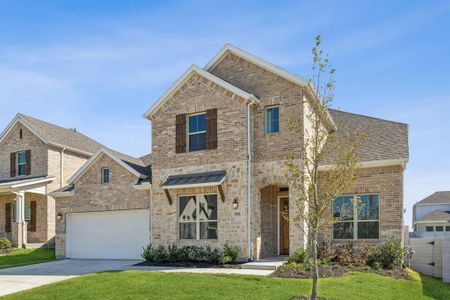 View of front facade featuring a garage and a front lawn