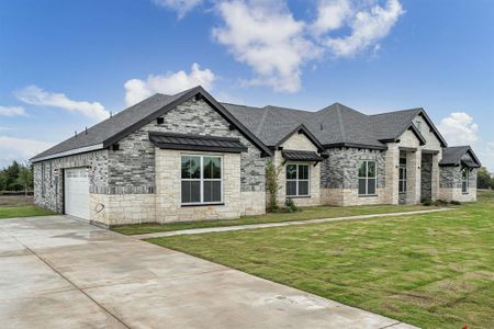 French country style house featuring a garage and a front yard