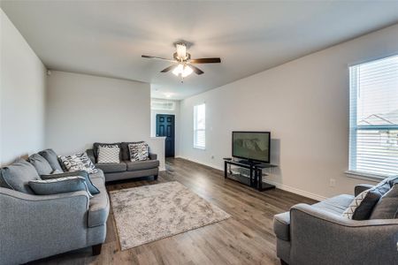 Living room featuring hardwood / wood-style flooring, plenty of natural light, and ceiling fan