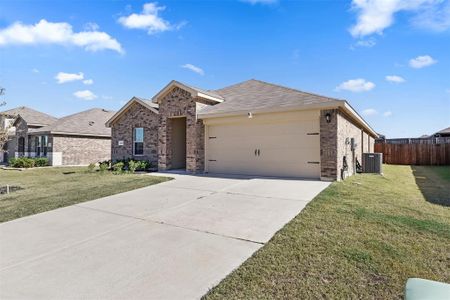 Ranch-style home featuring central AC unit, a garage, and a front yard