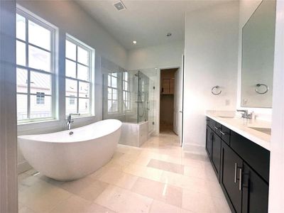 Gorgeous Marble Bathroom highlighted w/ Sleek Free Standing Tub, Seated Shower and Hans Grohe Plumbing Fixtures