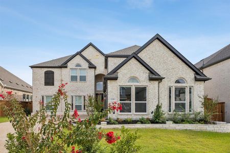 French country inspired facade featuring a front yard