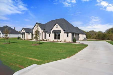 French country home featuring central air condition unit and a front yard