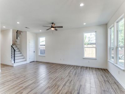 Unfurnished room featuring a healthy amount of sunlight, light wood-type flooring, and ceiling fan