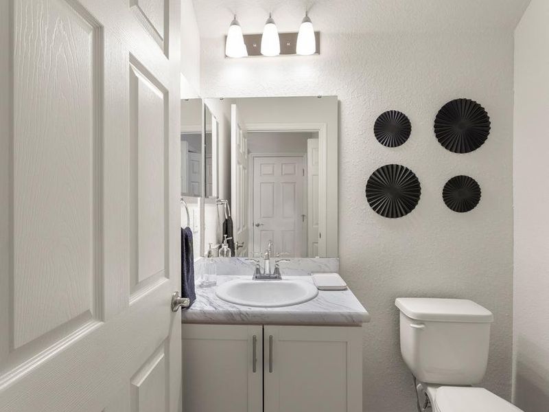 A convenient downstairs powder room serves your guests - Flora townhome model in St. Cloud, FL