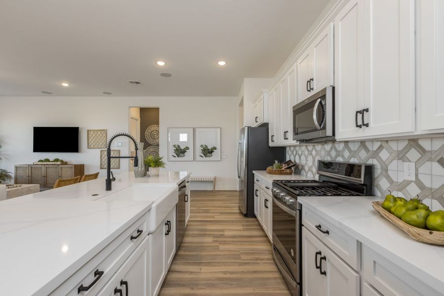 Jimson Floor Plan kitchen walkway. Easy to access kitchen sink to stove. Best way to cook meals with spacious and large counter tops  new home construction by William Ryan Homes Phoenix