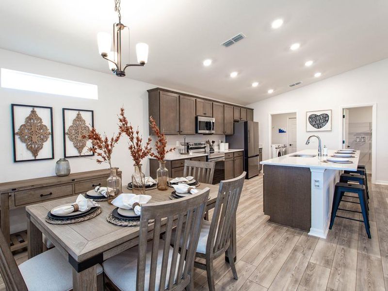 Your beautifully-designed kitchen includes a large island and sunny cafe, providing ample eating space - Serendipity model home in Zephyrhills