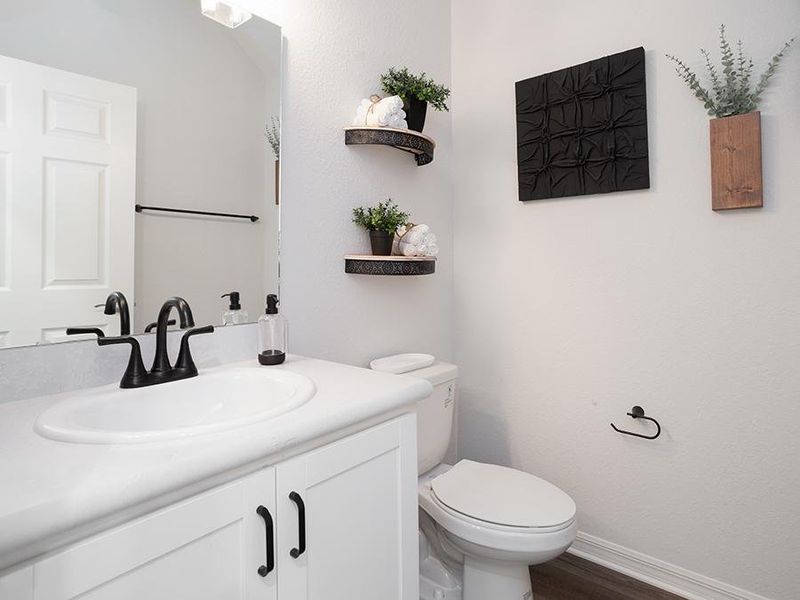 And, a convenient downstairs powder room is available for guests - Aria model home in St. Cloud, FL