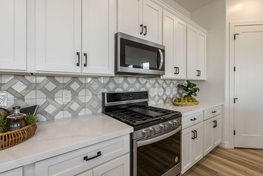 Jimson Floor Plan Kitchen Oven. Stainless Steel. With Electric Cooktop. Stainless steel microwave. Fruit basket new home construction by William Ryan Homes Phoenix