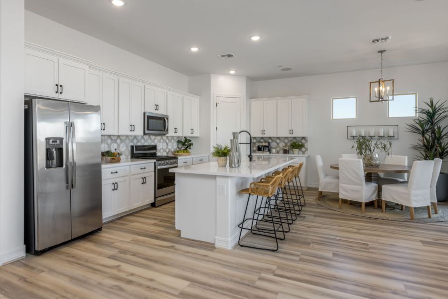 Jimson Kitchen. Stainless steel appliances, wood floors, white finishes. Breakfast Nook area new home construction by William Ryan Homes Phoenix