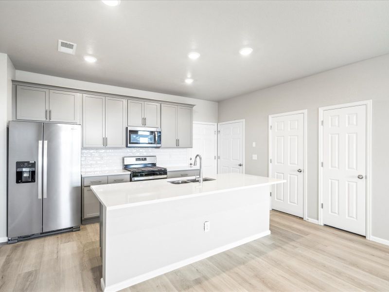 Kitchen in the Orchard floorplan at a Meritage Homes community in Aurora, CO.